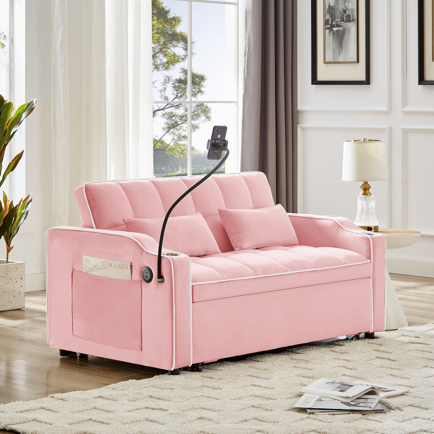 Pink velvet sofa bed with white piping featuring a phone holder cup holder and side pocket