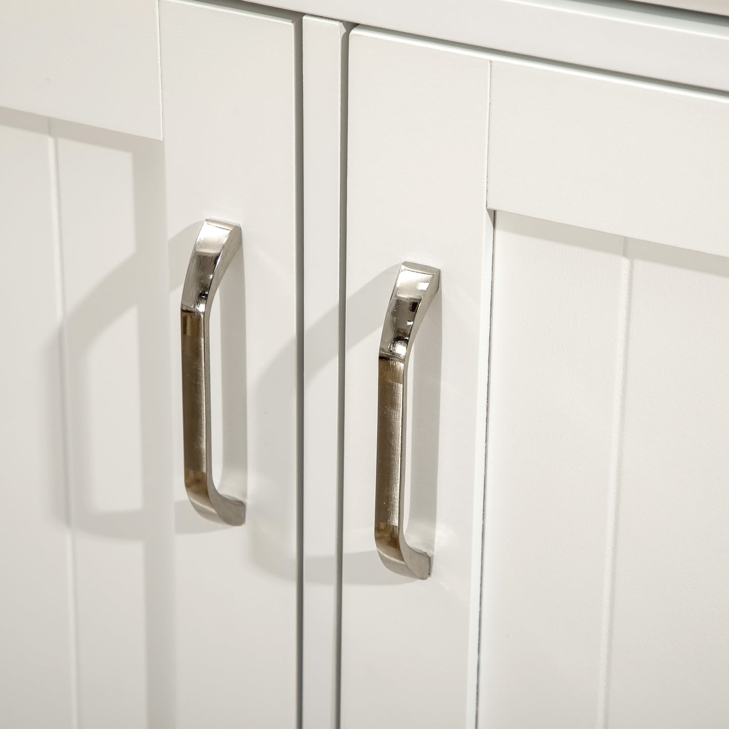 Pair of brushed nickel cabinet handles on white shakerstyle doors