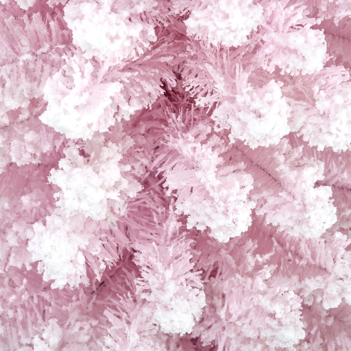 Closeup of flocked pink artificial Christmas tree branches adding a festive touch