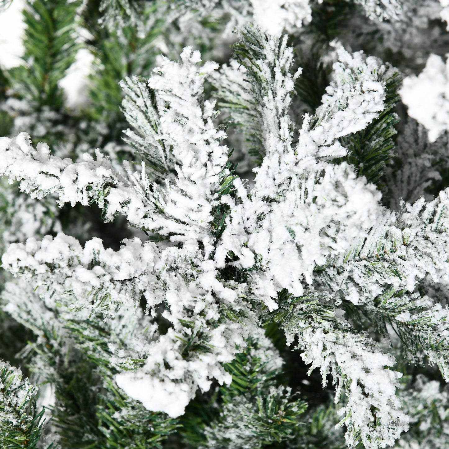 Close up of flocked pine branches with realistic snow effect for Christmas decor