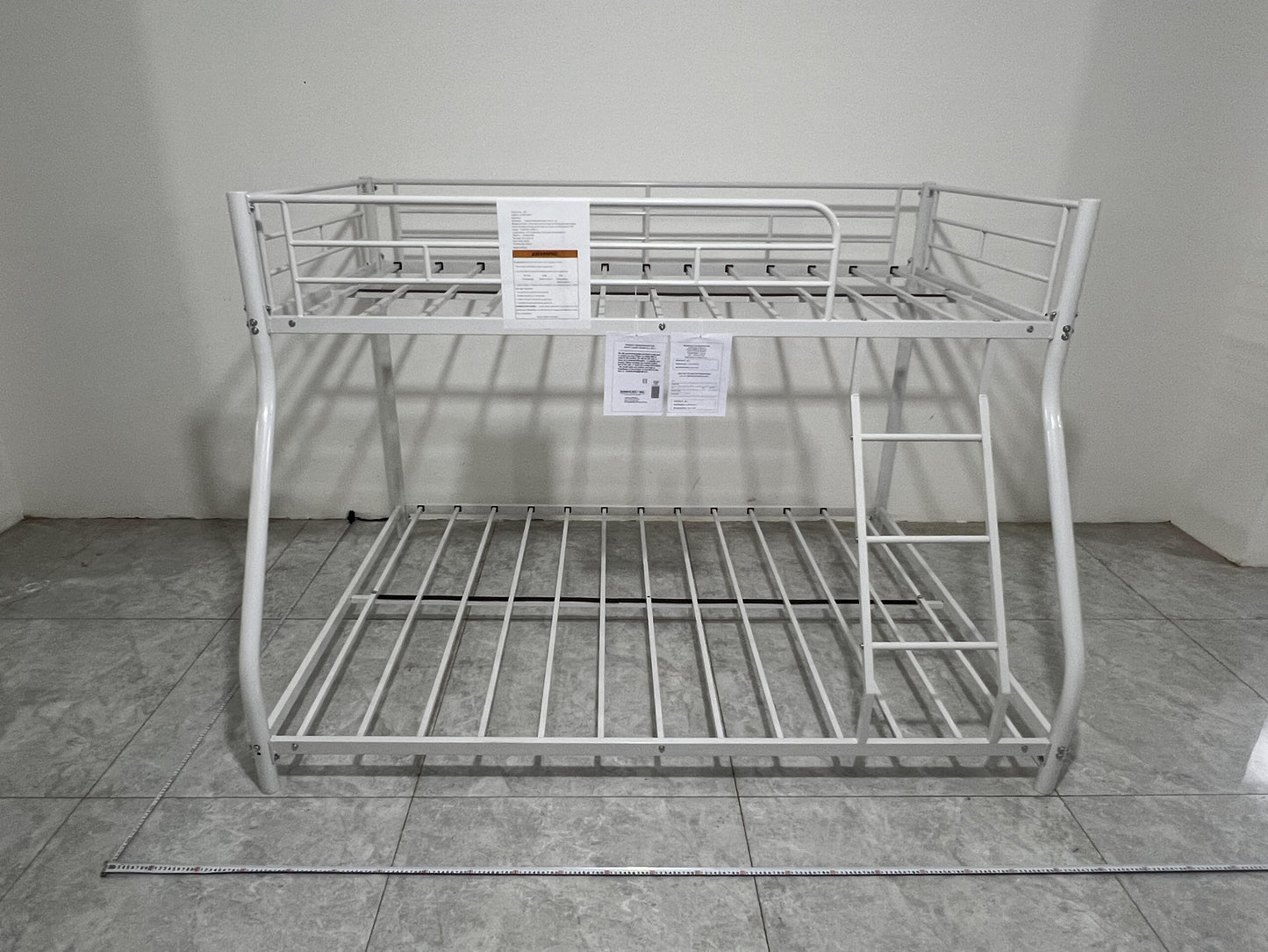 White metal twin over twin bunk bed with ladder and safety rails