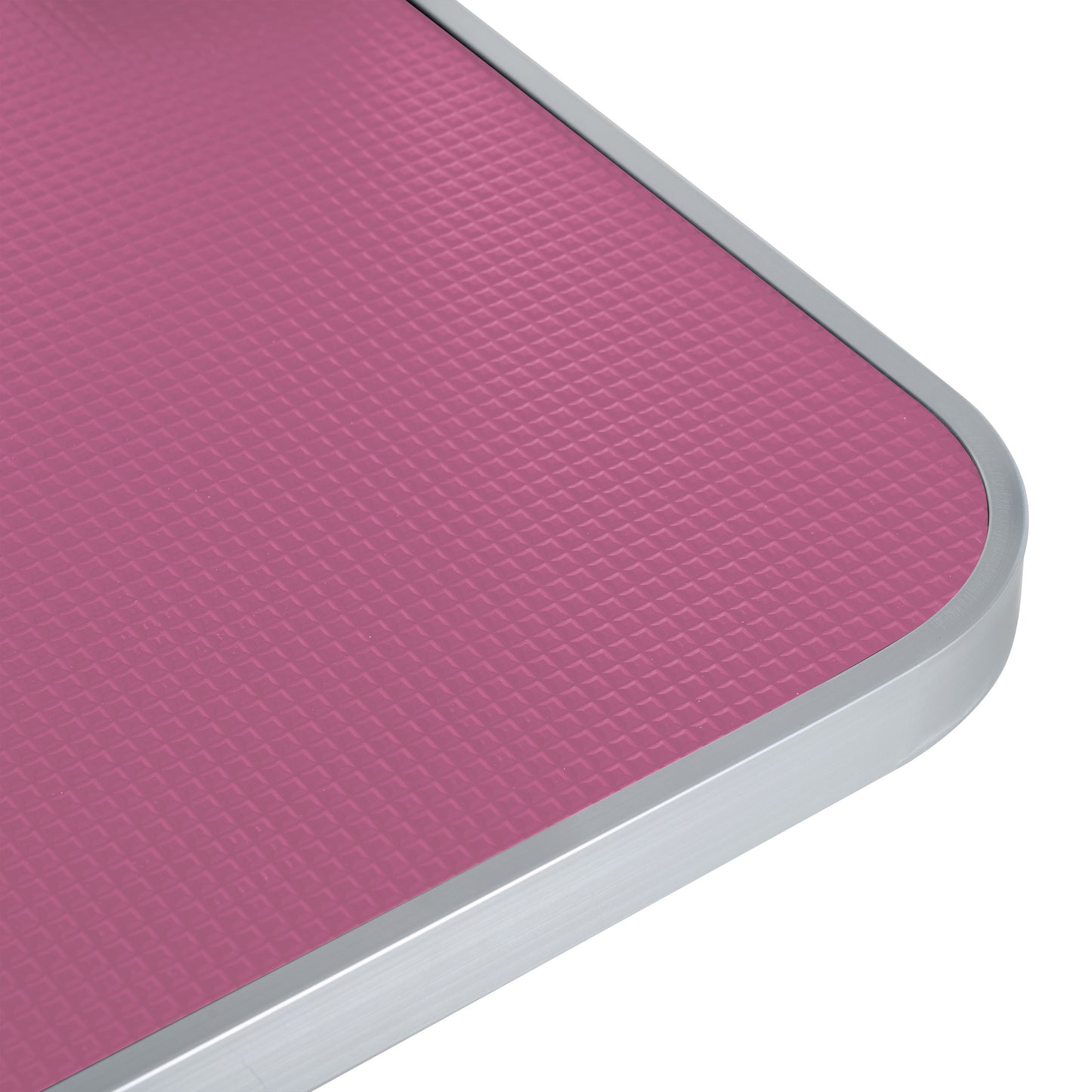 Textured pink dog grooming table surface with brushed aluminum edge