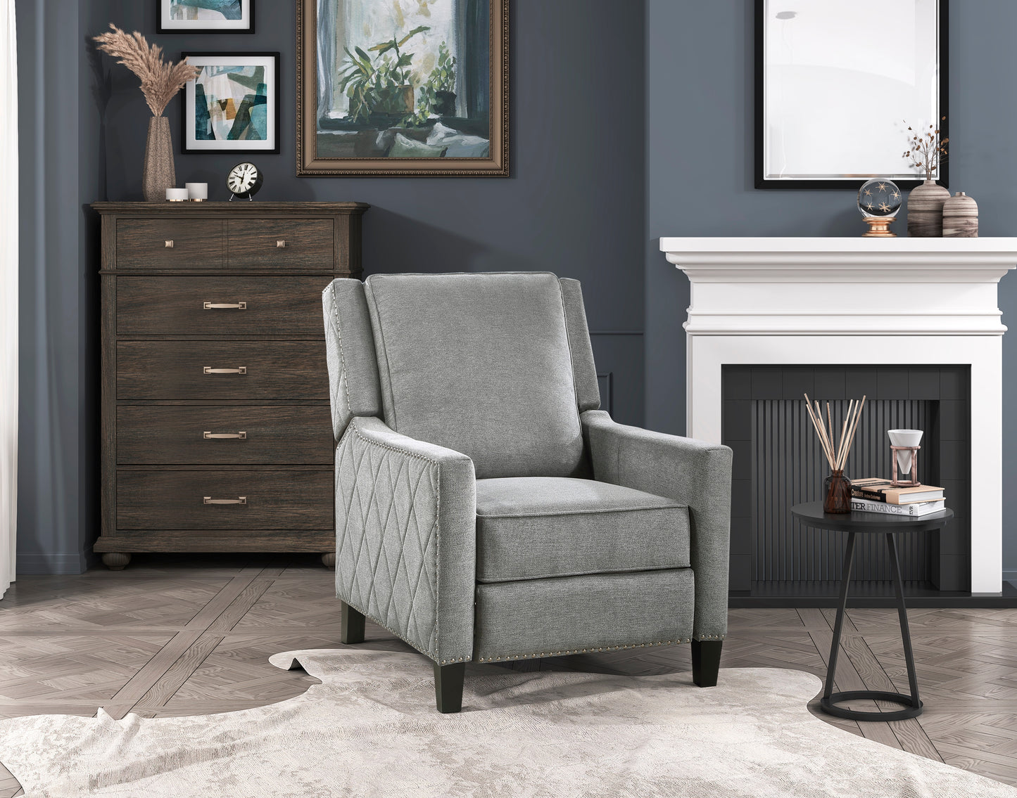 Gray upholstered recliner chair with diamondstitched arms and nailhead trim