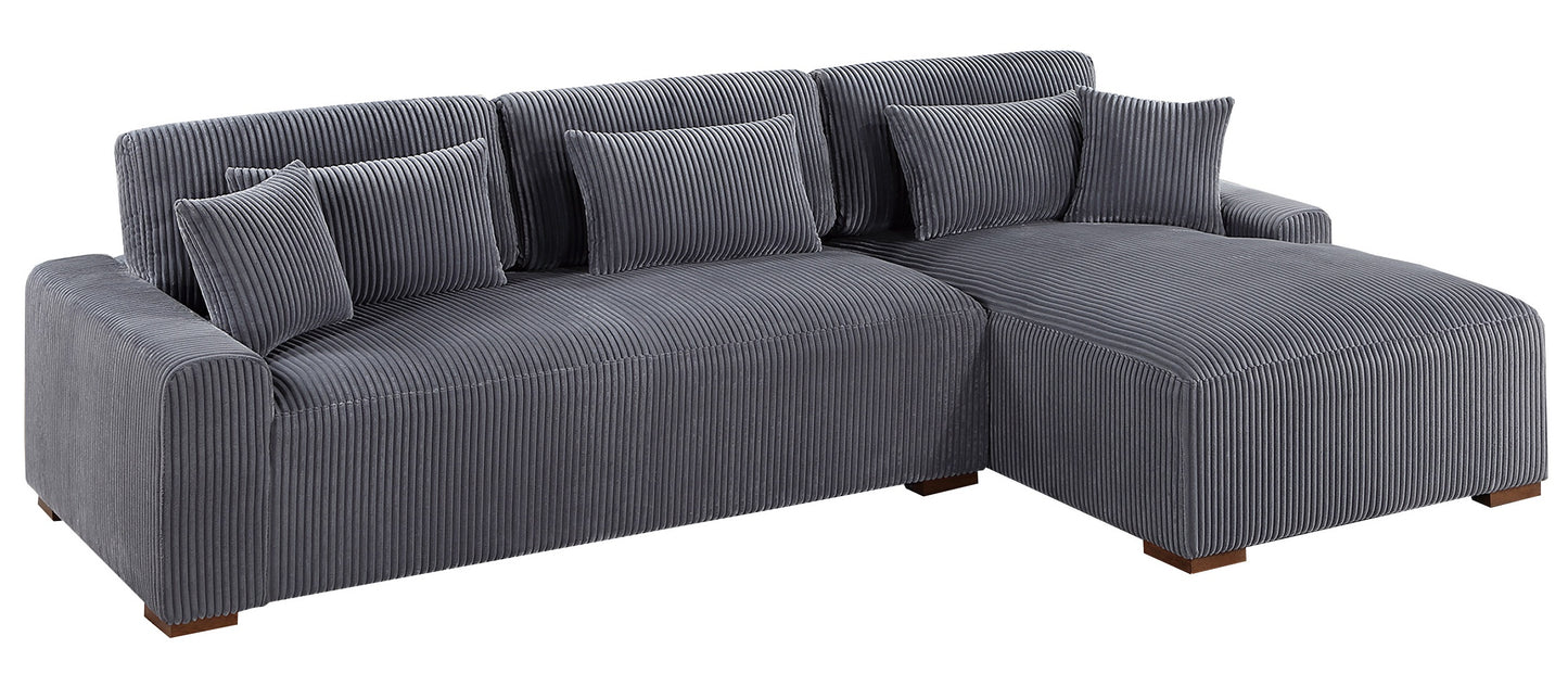 Grey corduroy sectional sofa with plush throw pillows perfect for a modern living room