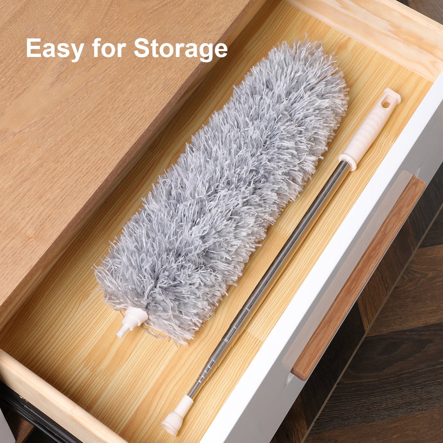 Gray microfiber duster with telescoping handle stored in a wooden drawer