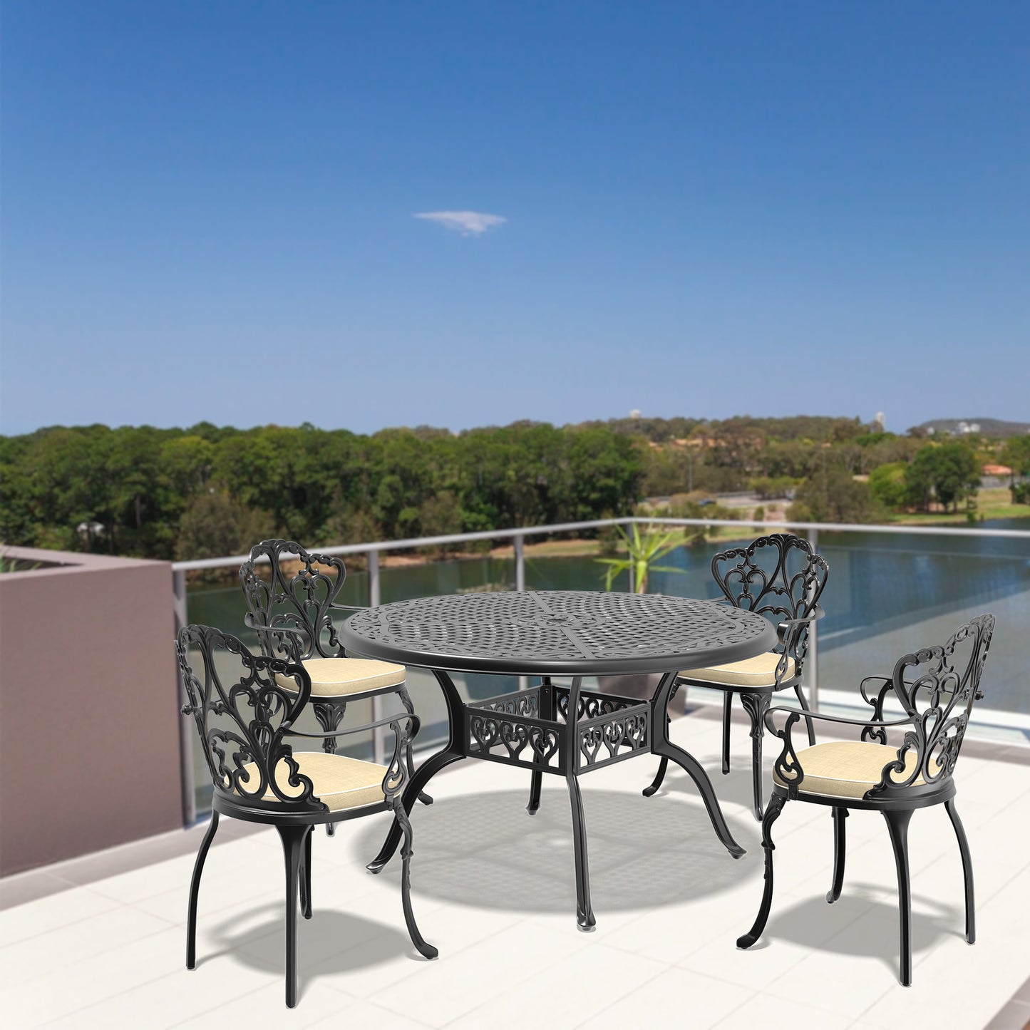 Ornate black cast aluminum patio dining set with four chairs and round table