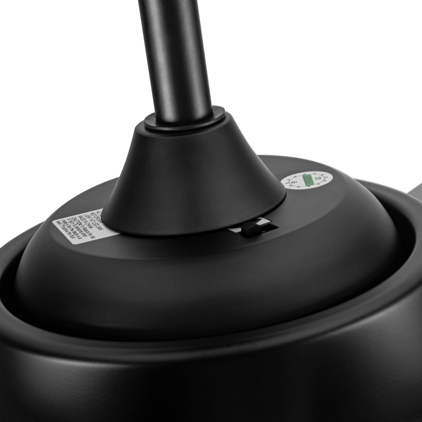 Closeup of a black ceiling fan motor housing with a speed control switch