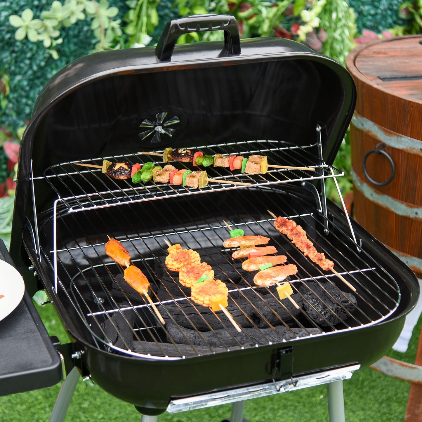 Black charcoal grill with assorted meat and vegetable skewers cooking on its grates