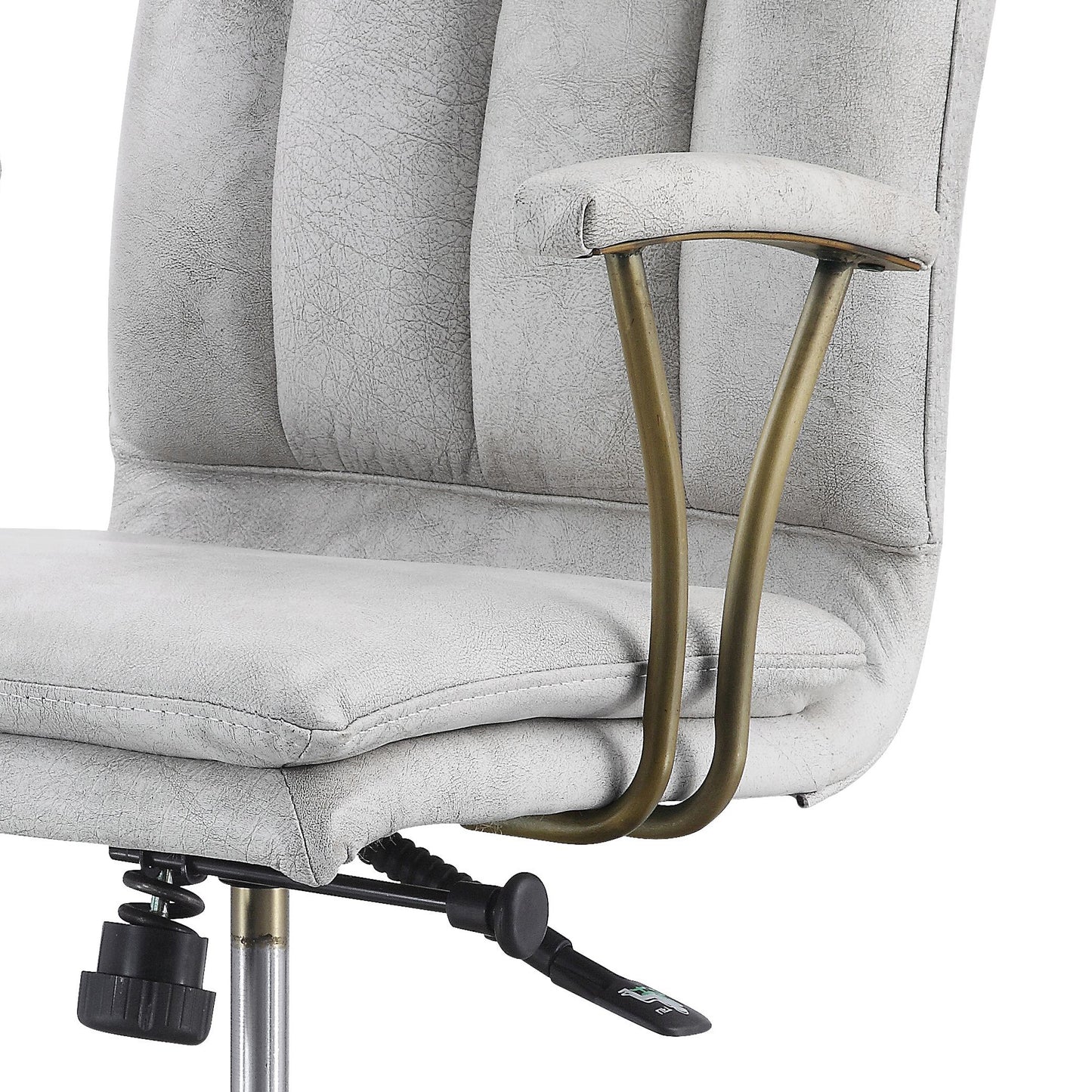Closeup of a light gray faux leather office chair seat and armrest with brushed brass accents