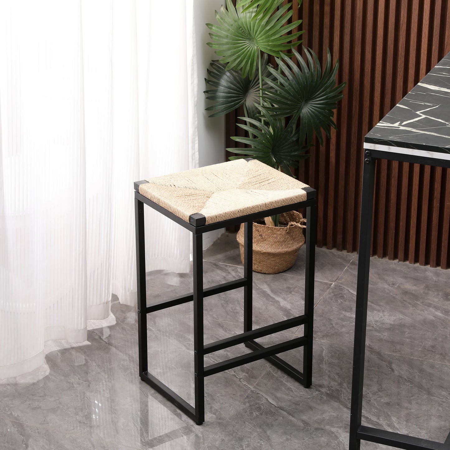 Modern bar stool with woven natural fiber seat and black metal frame