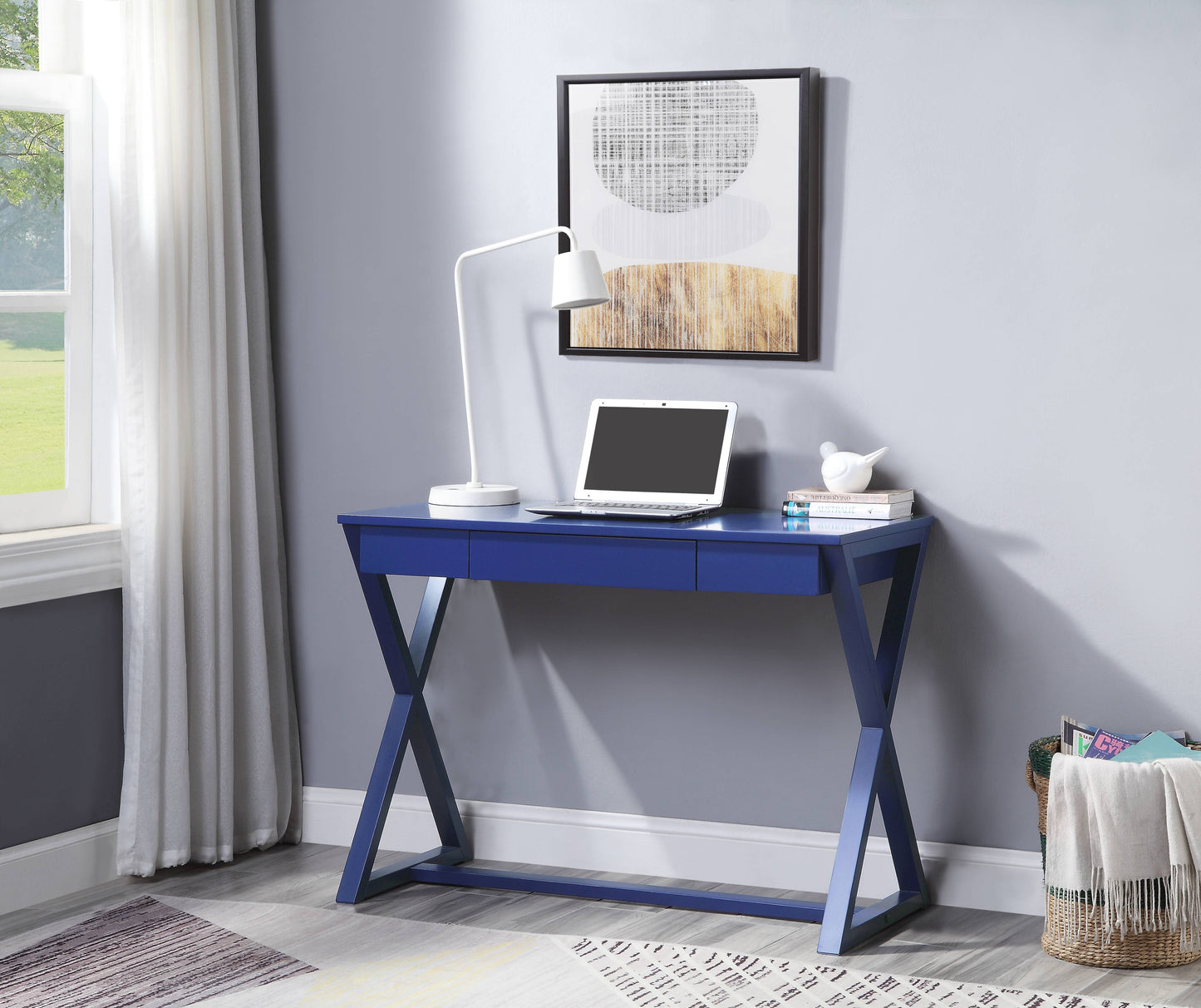 Sleek navy blue desk with Xframe legs featuring three drawers and a modern laptop for home office use