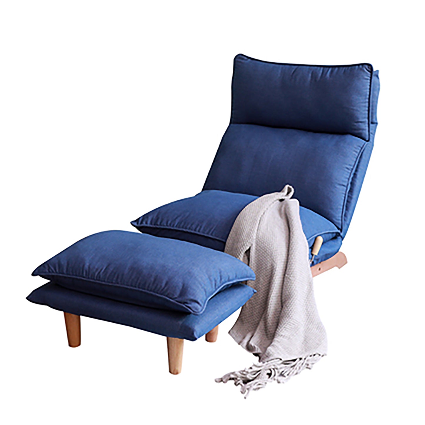 Navy blue upholstered lounge chair with adjustable back and matching ottoman featuring wooden legs and a grey throw blanket
