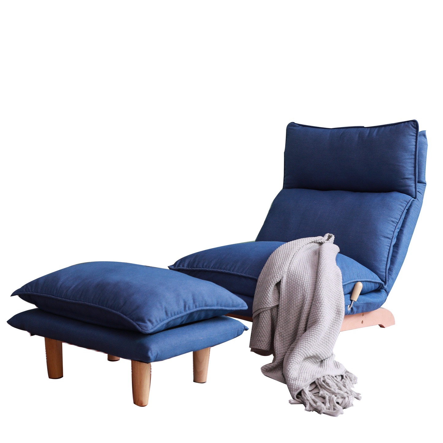 Navy blue upholstered lounge chair with wooden legs and matching ottoman draped with a grey throw