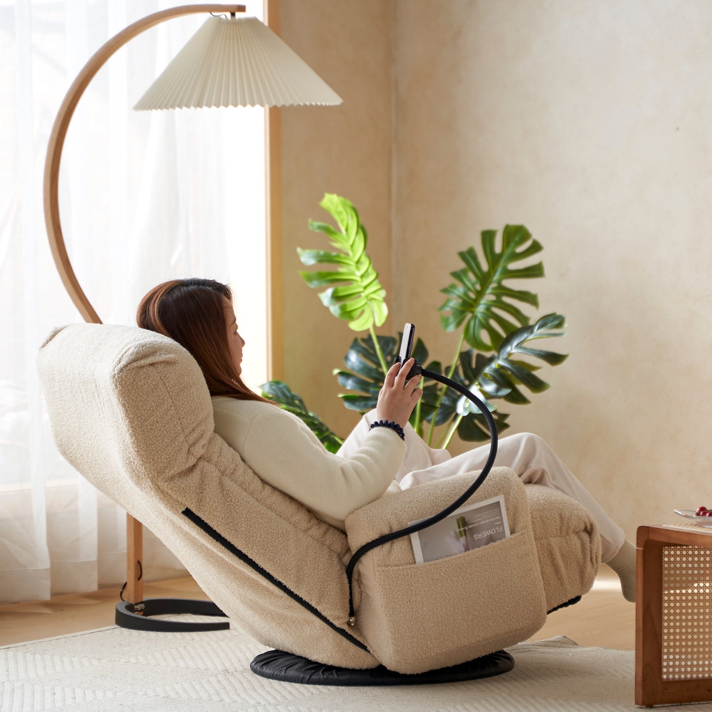 Cream sherpa lounge chair with adjustable phone holder and side pocket for relaxation