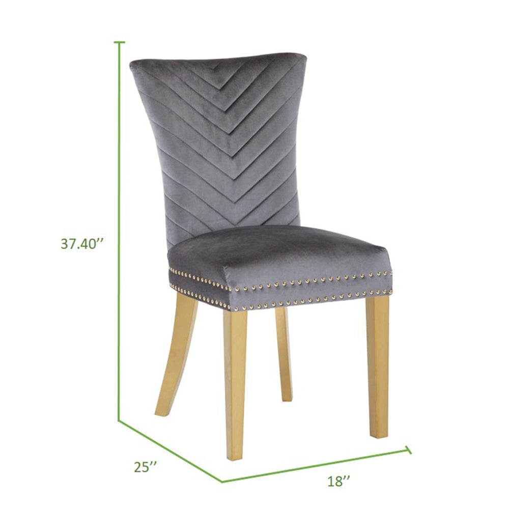 Grey velvet dining chair with chevron back and brass studs