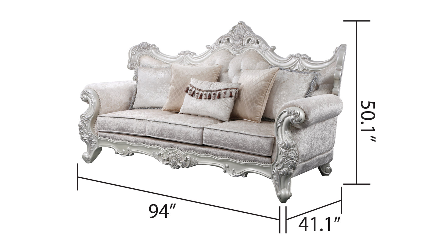Ornate cream velvet sofa with tufted back plush cushions and intricate silver wood trim Ideal for elegant living rooms