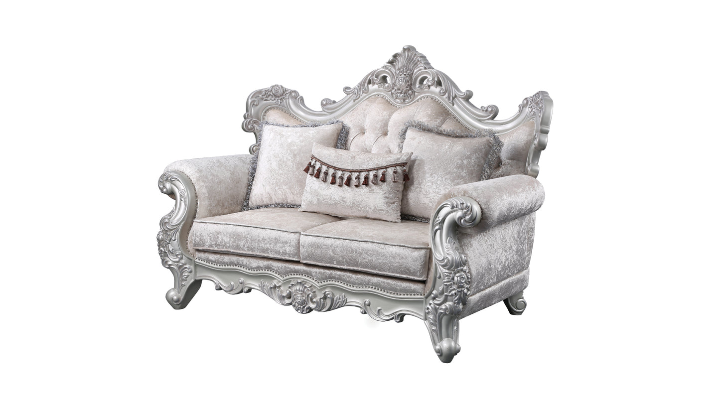 Elegant ivory loveseat with ornate silver carved wood frame and plush velvet upholstery