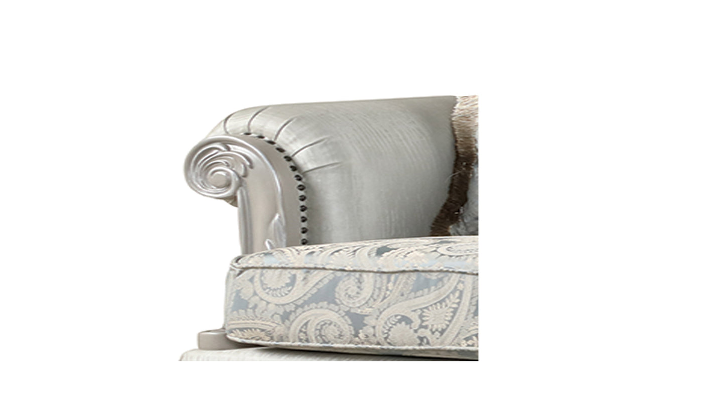 Elegant upholstered armchair with silver fabric ornate scrolling arm and paisley seat cushion