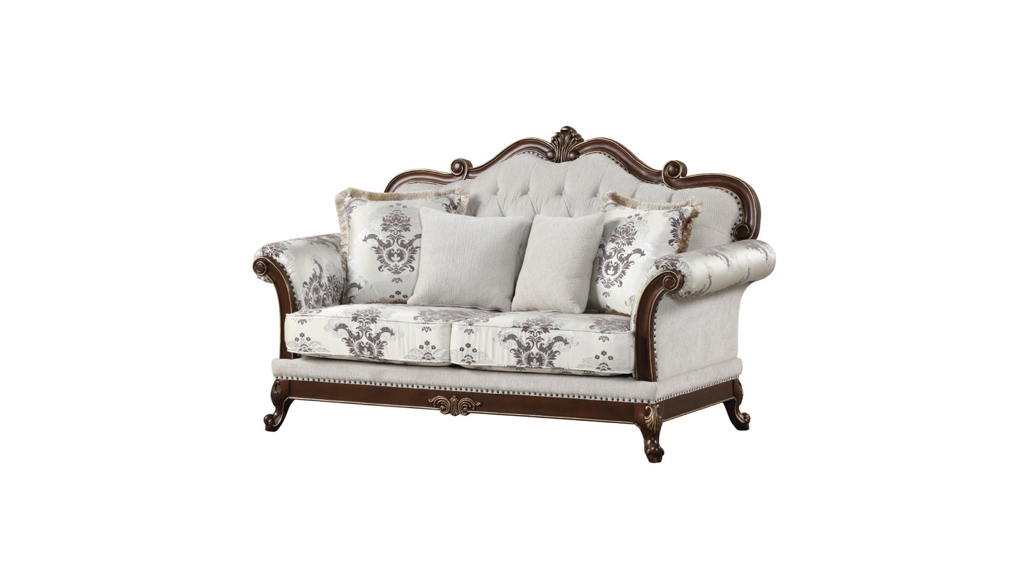 Ornate carved wood frame loveseat with cream damask upholstery and accent pillows