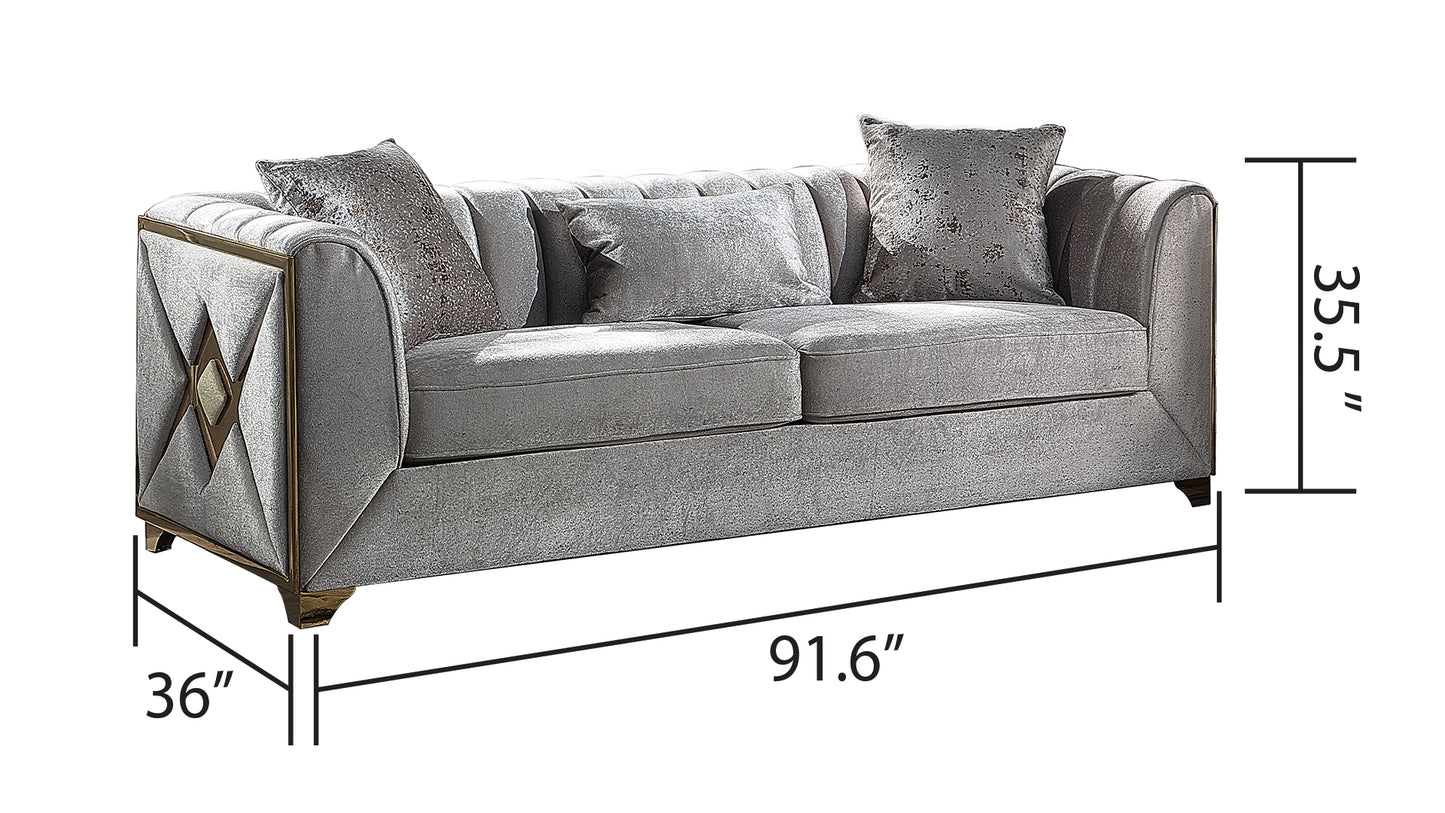 Luxurious silver velvet sofa with diamond tufting and gold accents