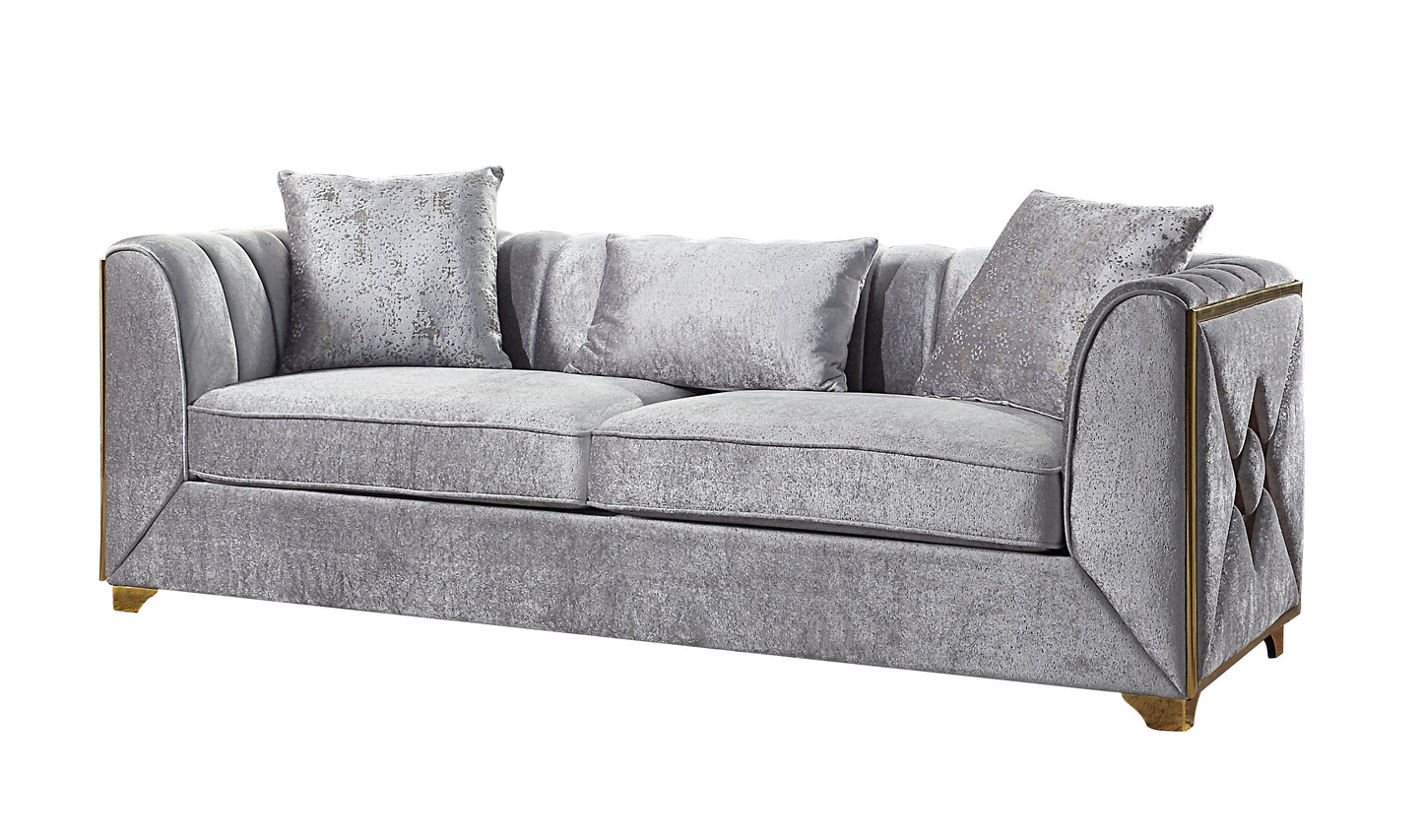 Elegant silver velvet sofa with plush cushions and gold trim accents