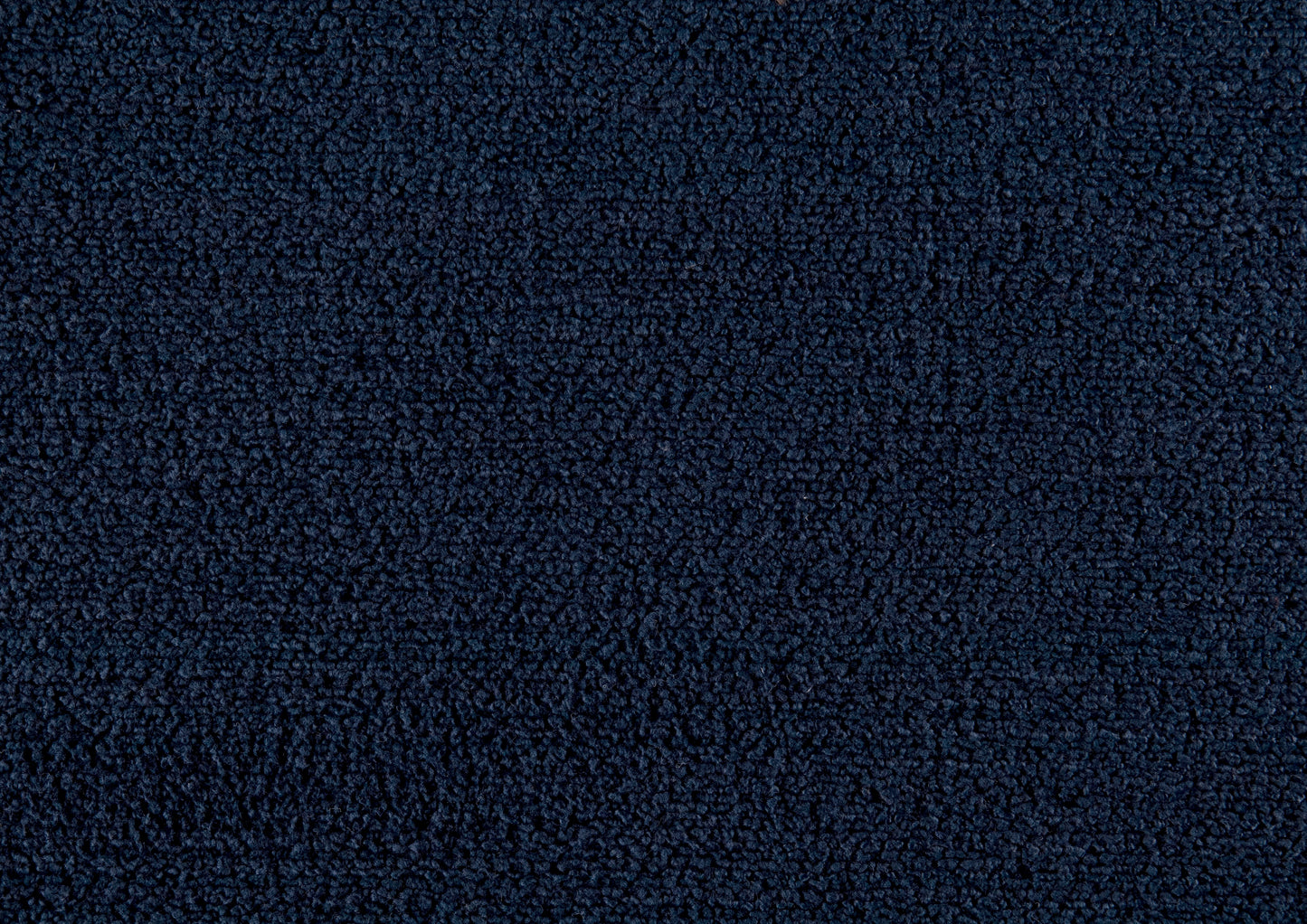 Textured navy blue fleece fabric showing soft looped fibers for cozy apparel