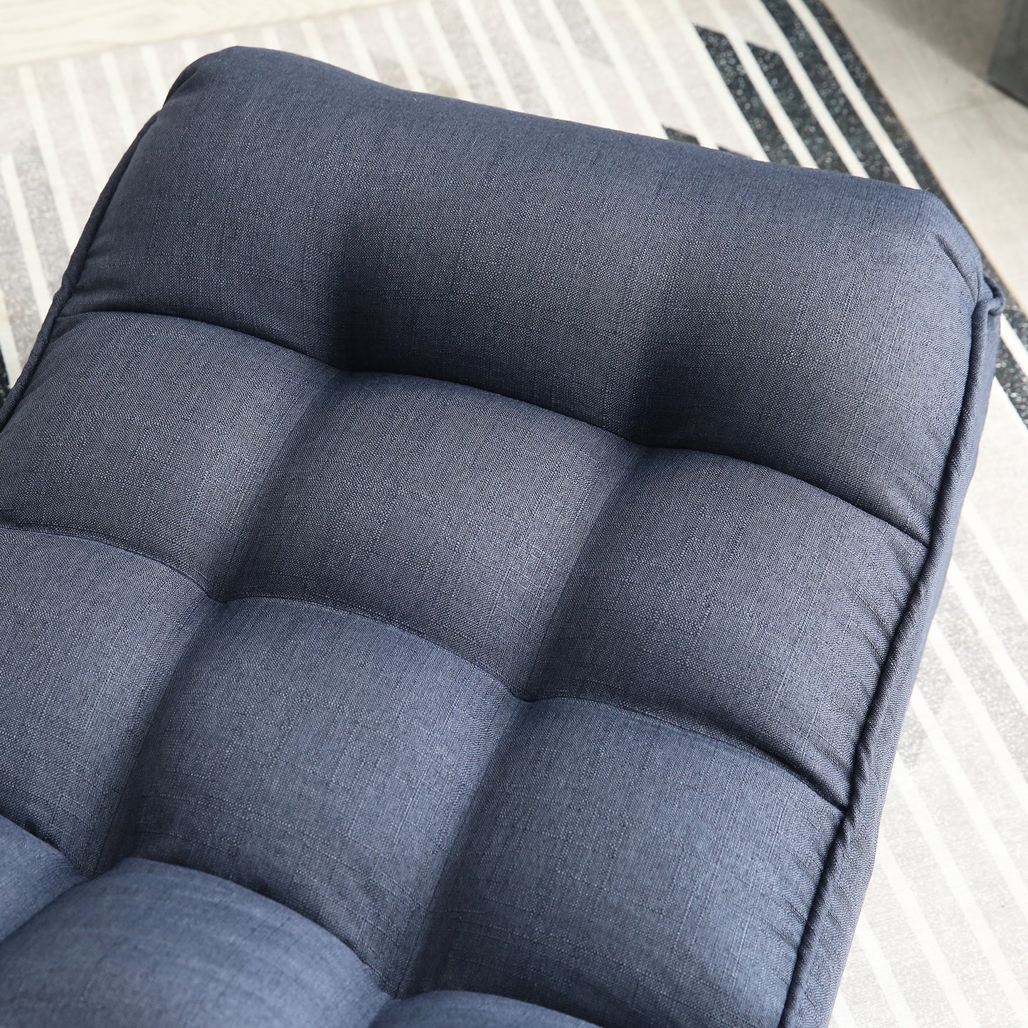 Tufted navy blue fabric accent chair with button details for modern living spaces