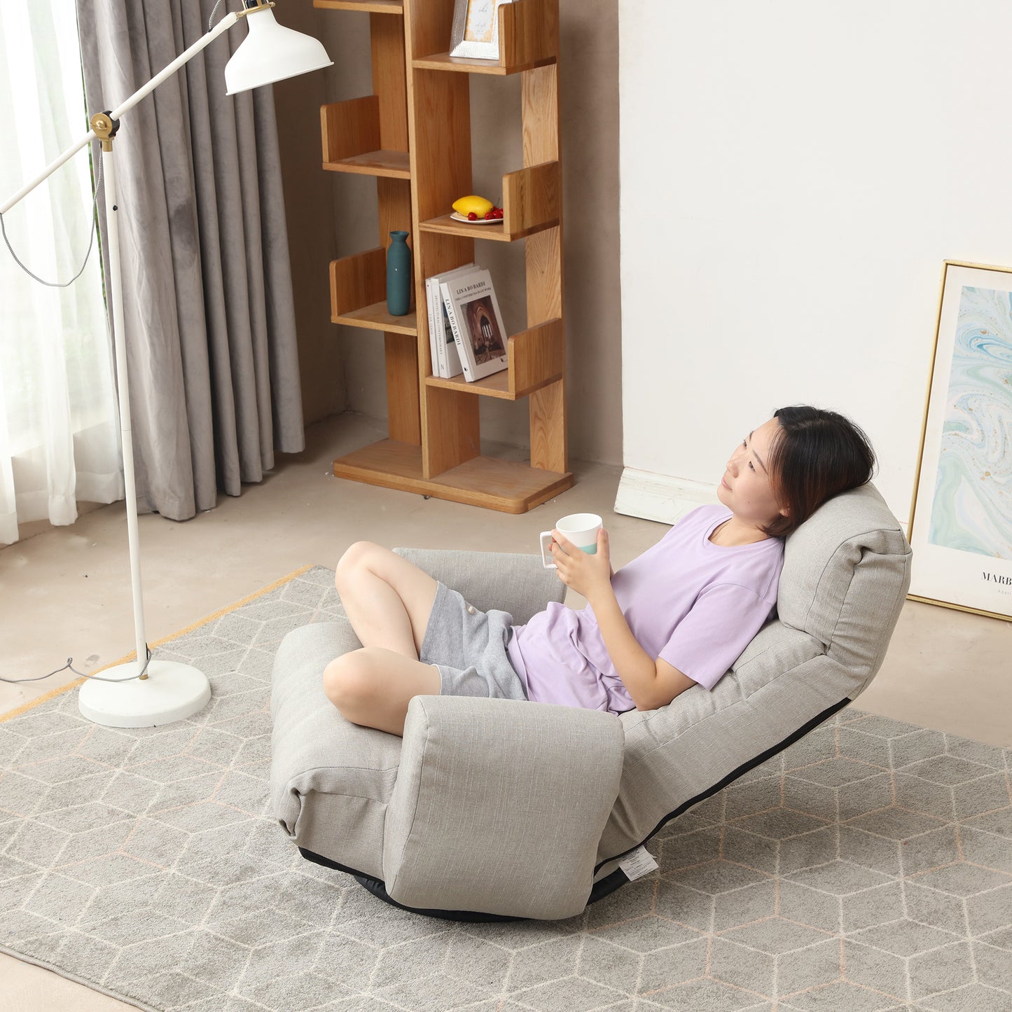 Adjustable grey linen floor chair with integrated armrests perfect for a relaxing reading nook