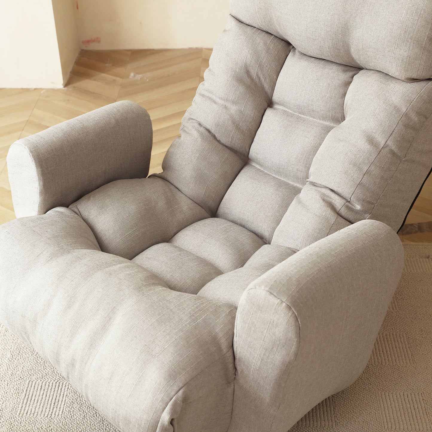 Plush beige floor chair with adjustable backrest and padded seat for ultimate comfort