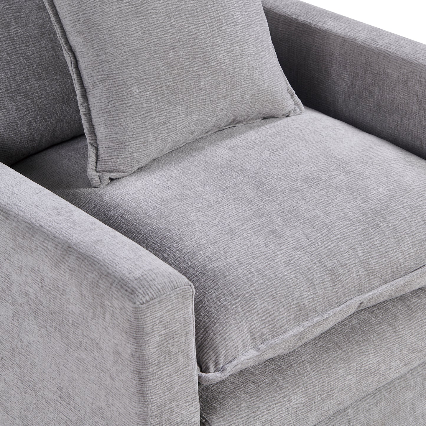 Closeup of a textured light gray fabric armchair cushion with a matching throw pillow