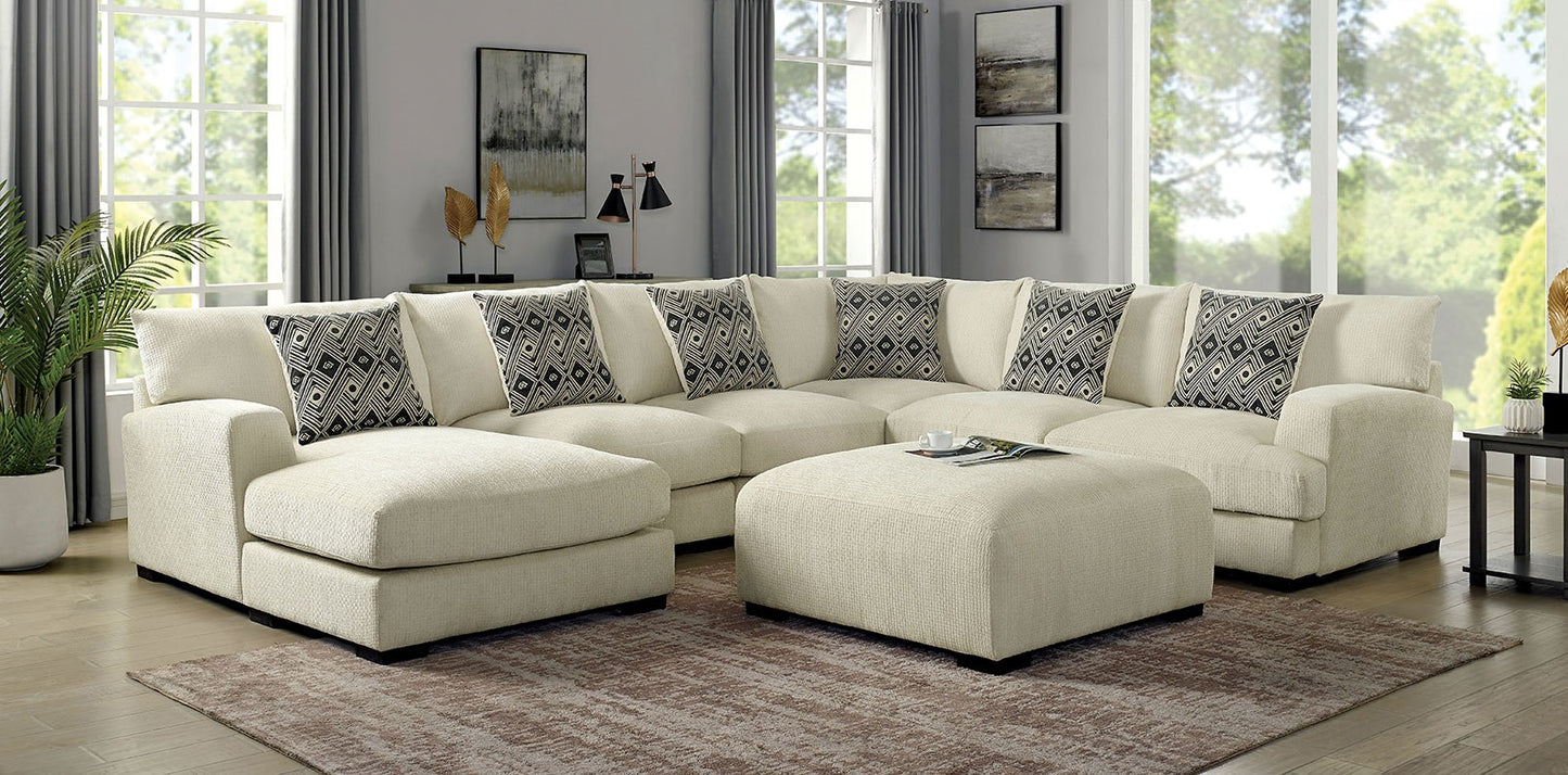 Cream sectional sofa with decorative geometric throw pillows and matching ottoman
