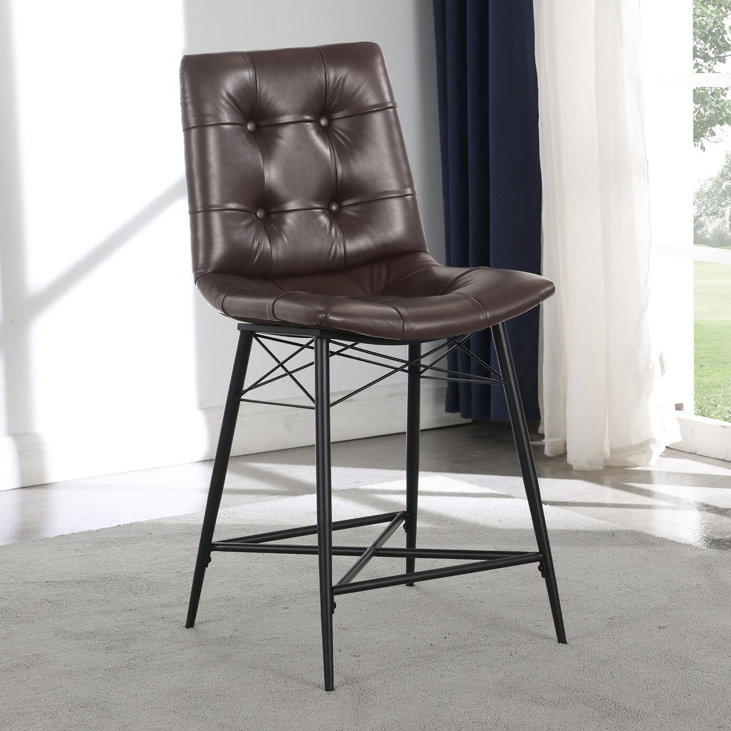 Tufted brown faux leather bar stool with black metal legs and footrest