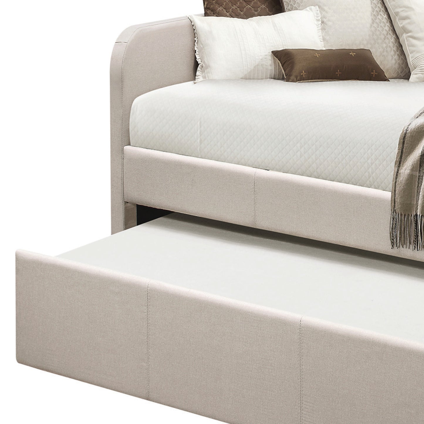 Beige upholstered daybed with a pullout trundle bed for guest use