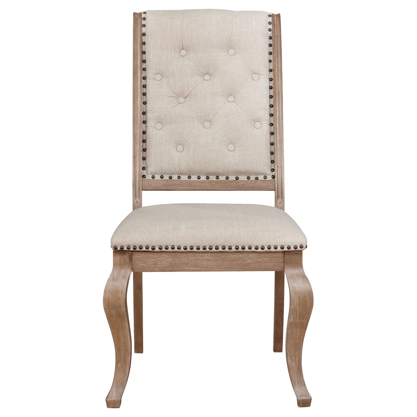 Tufted beige fabric dining chair with antique brass nailhead trim and carved wooden legs