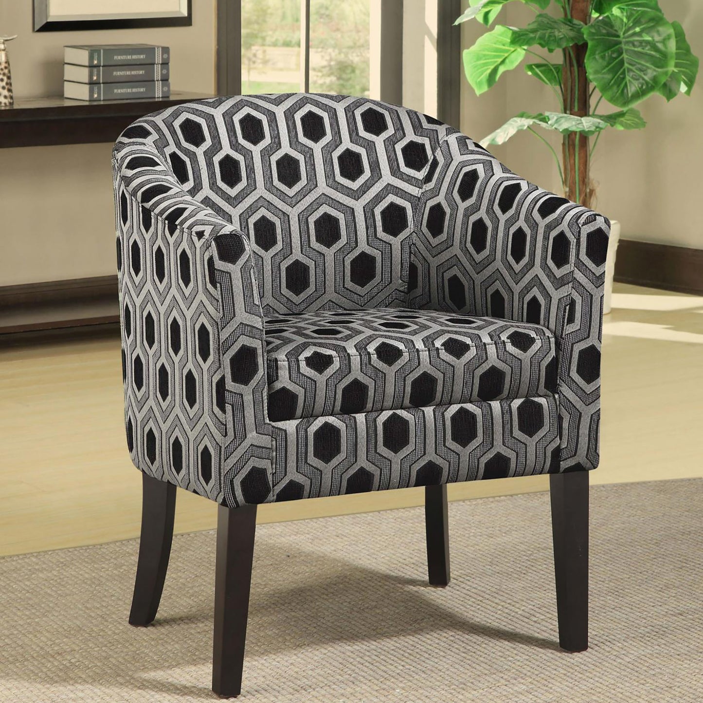 Accent chair with a bold geometric pattern in black and silver fabric