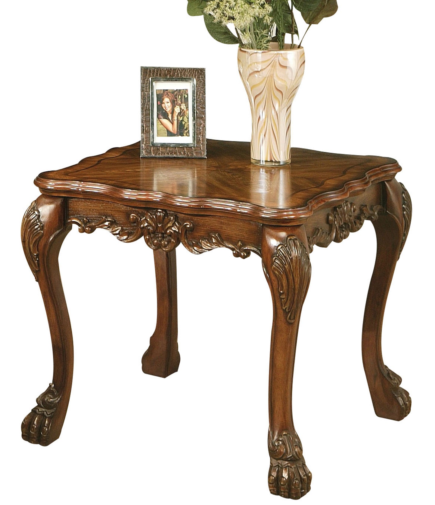 Antique mahogany end table with ornate carved claw feet and decorative inlay details