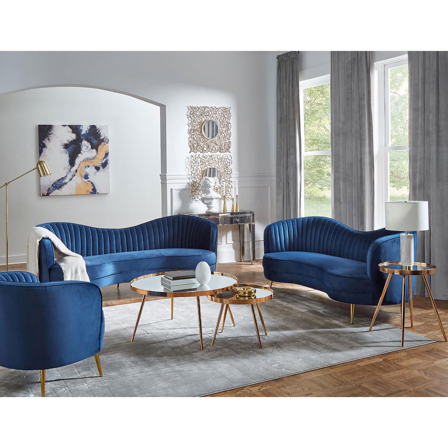 Deep blue velvet sofa with channeled tufting featuring elegant gold legs for a luxurious living room