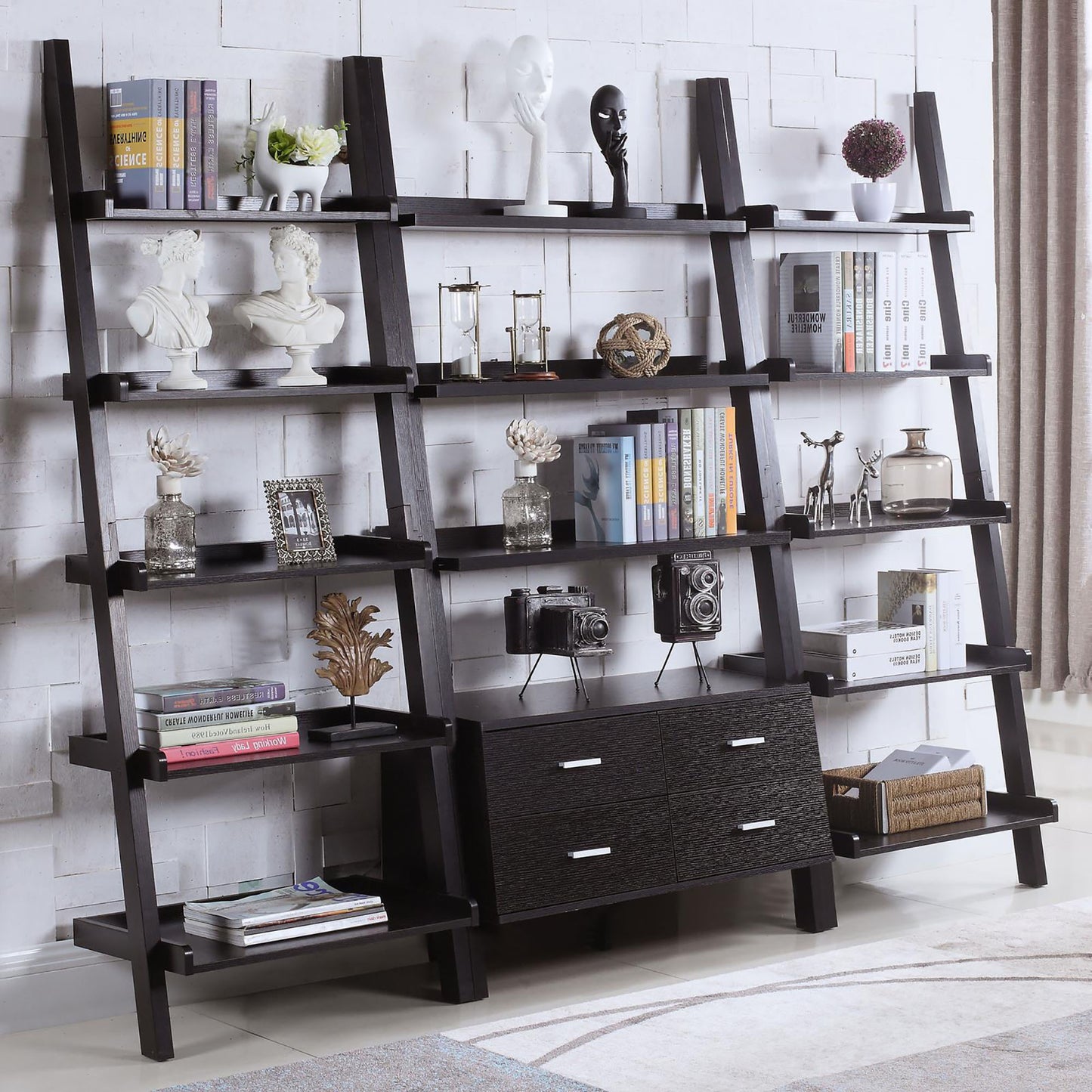 Black ladder bookshelf with decorative busts and books