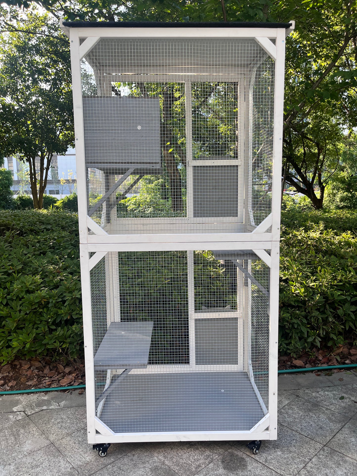 Twotier white outdoor cat enclosure with platforms and wheels