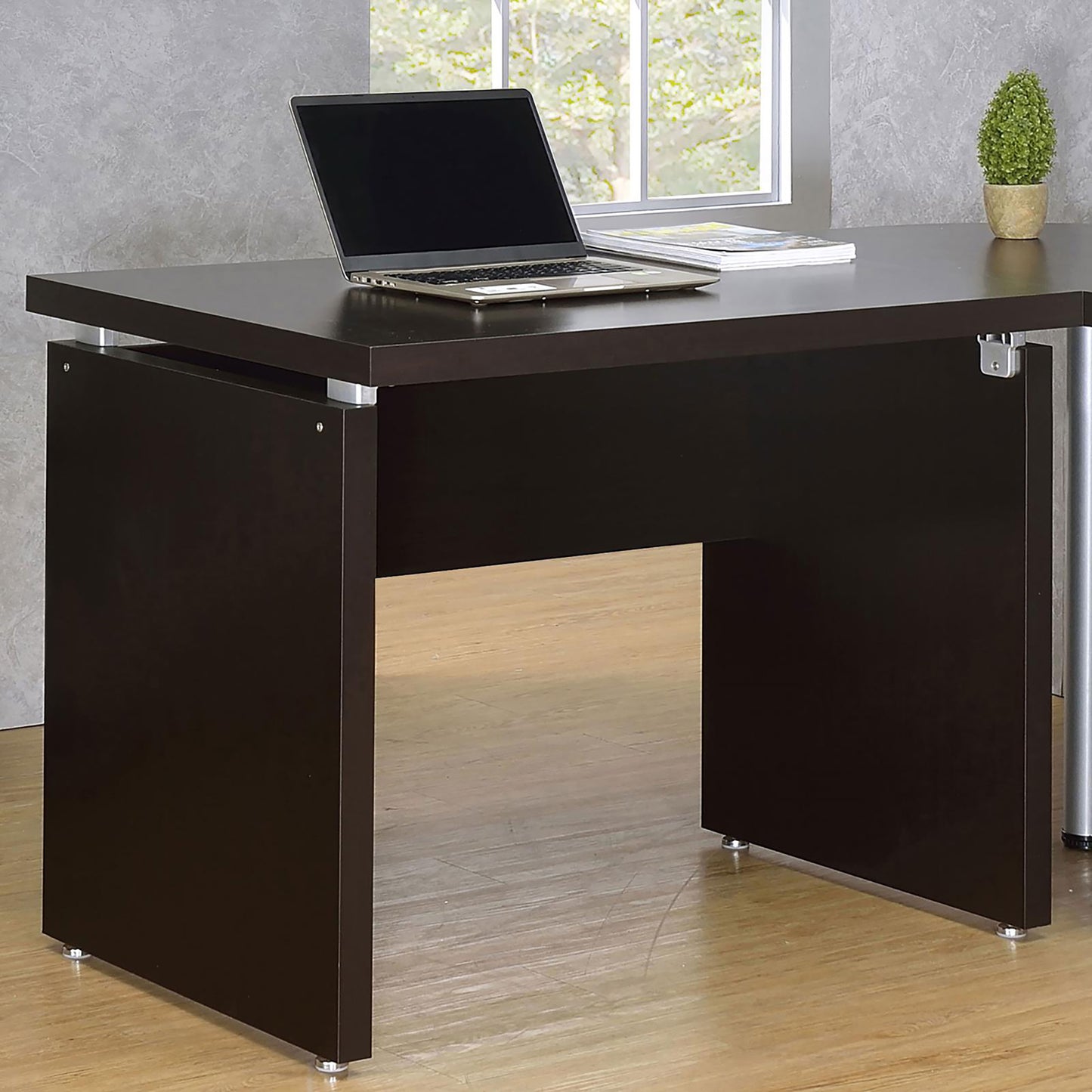 Dark brown modern computer desk with silver accents and laptop
