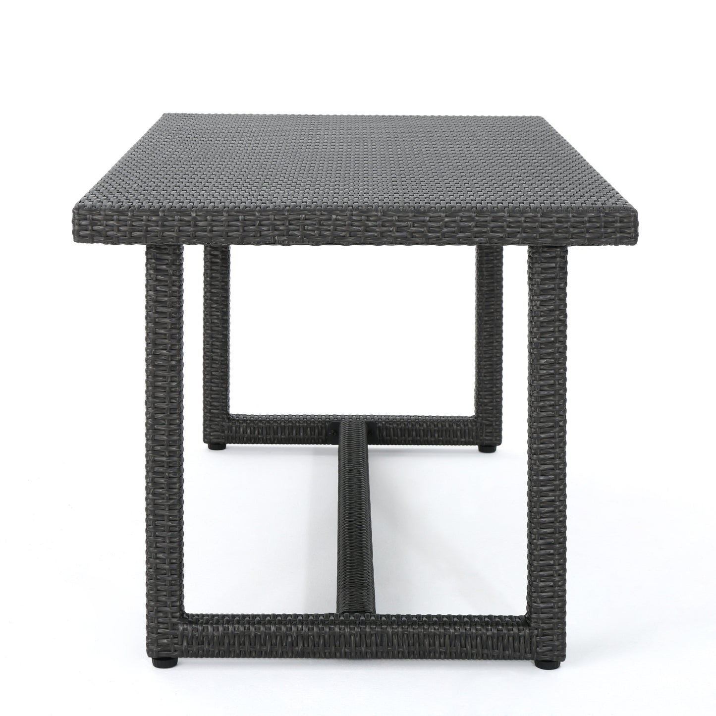 Dark grey rattan dining table with textured surface and sturdy legs