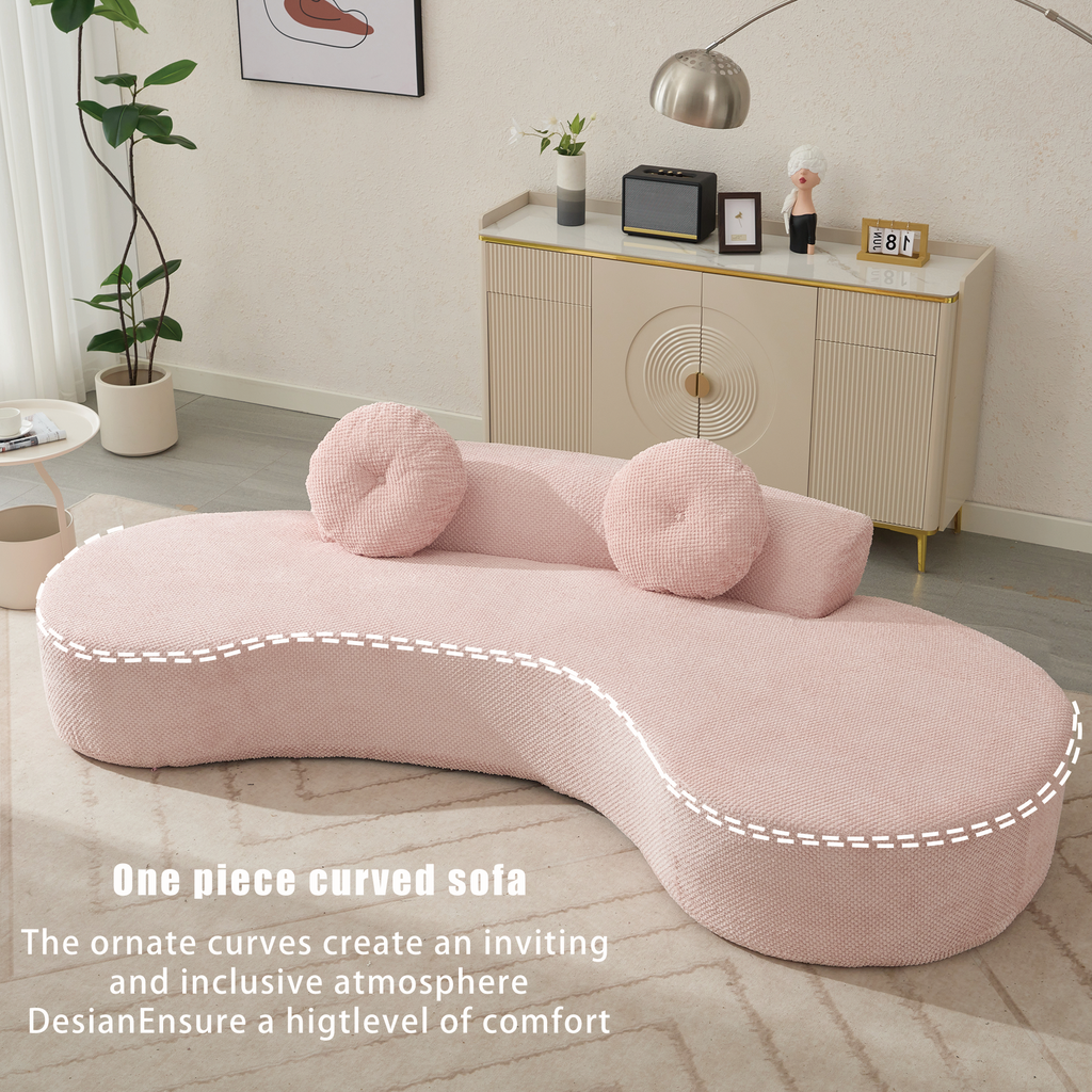 Pink one piece curved sofa with plush textured fabric and round throw pillows