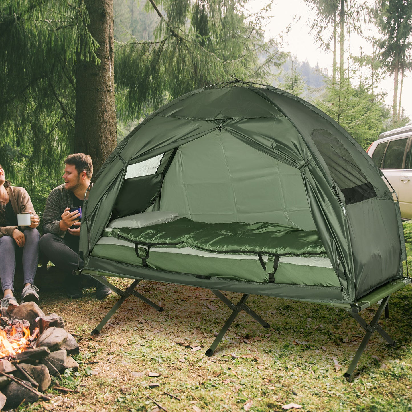 Green camping tent with builtin elevated cot featuring a sleeping bag and pillow for comfortable outdoor adventures