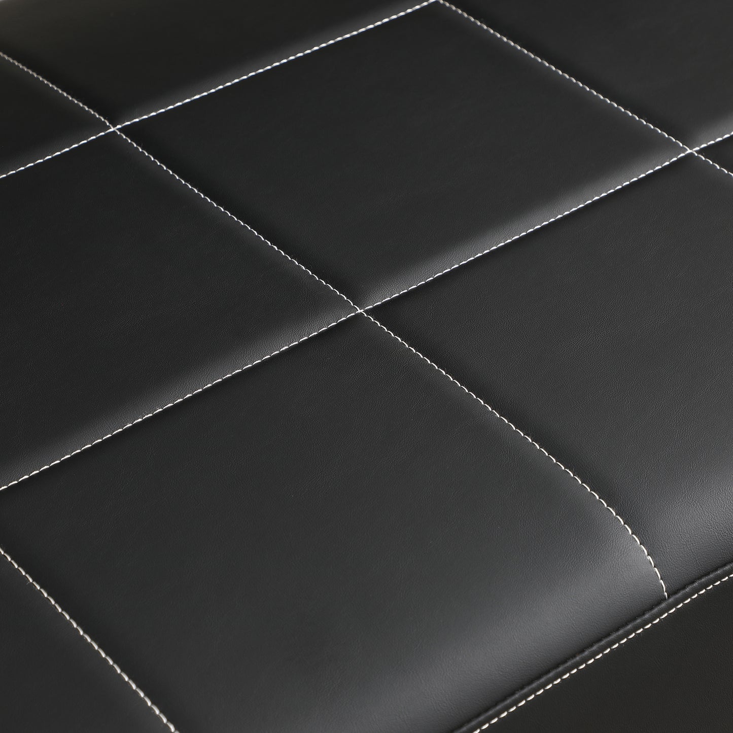 Closeup of black faux leather with diamond stitching perfect for upholstery