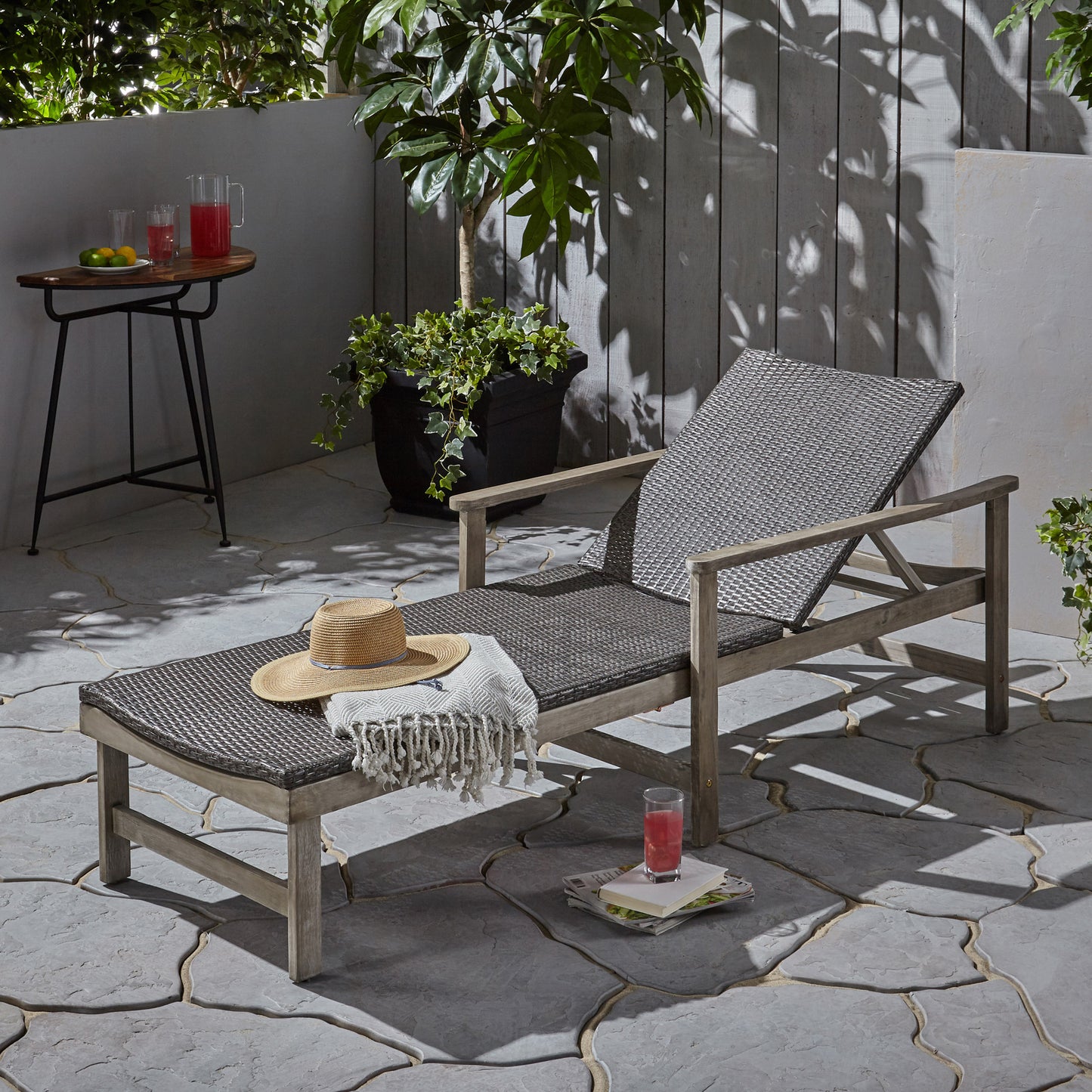 Woven grey rattan patio chaise lounge with wooden frame and adjustable backrest
