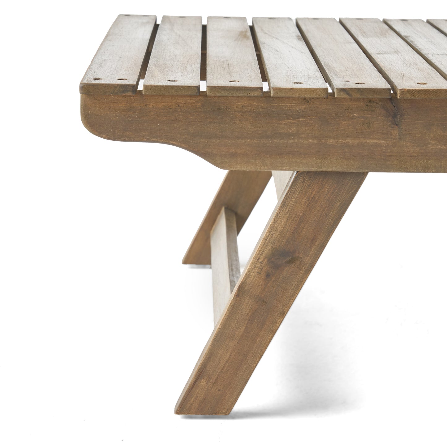 Closeup of a rustic wooden picnic table with a slatted top and angled legs