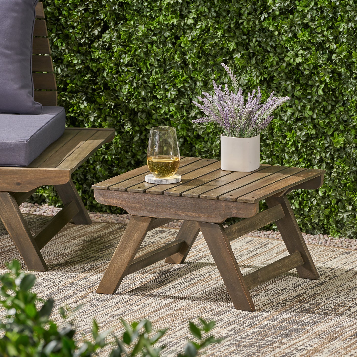 Dark brown slatted wood outdoor side table with metal accents perfect for patios