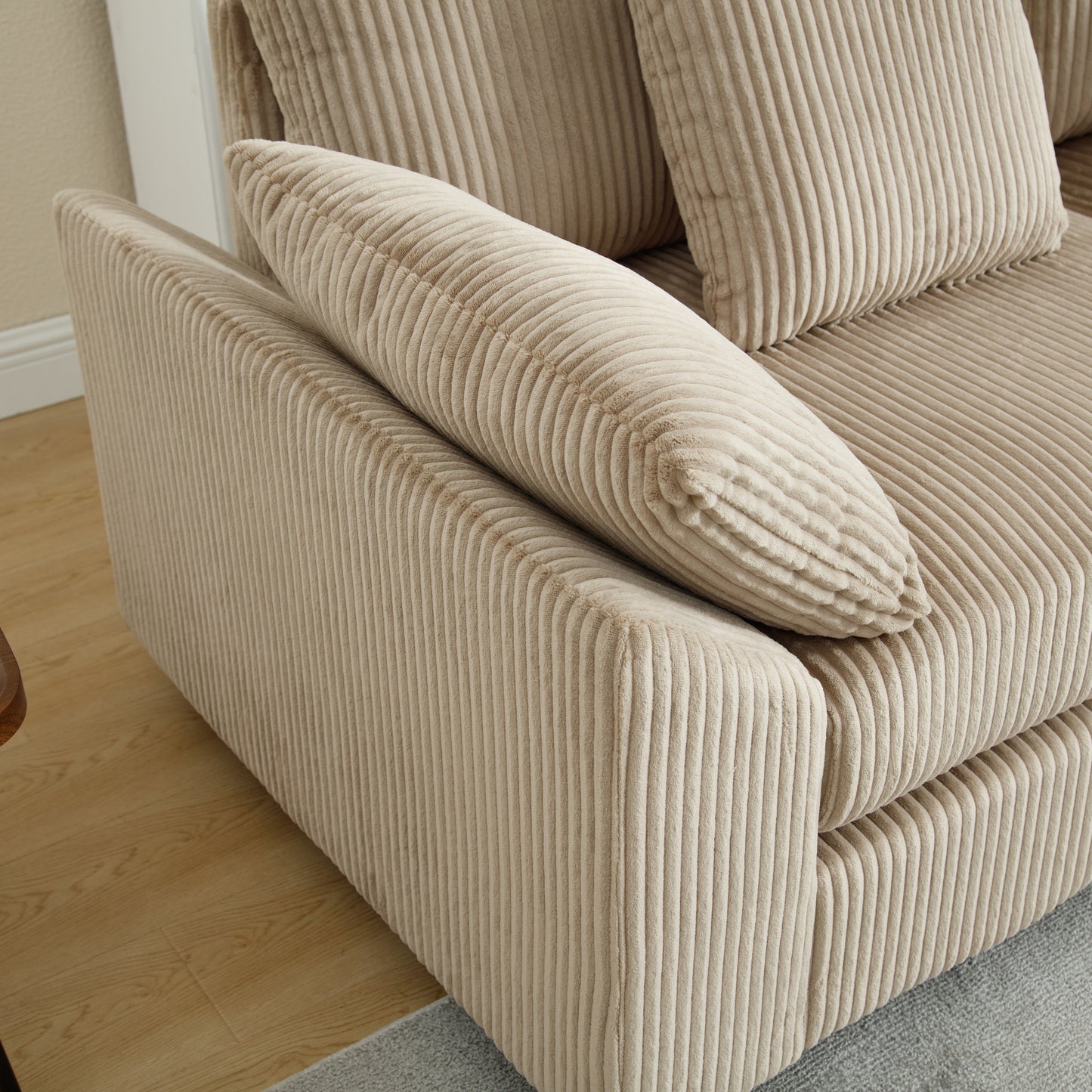 Beige corduroy sofa with plush cushions offering a comfortable and inviting seating option