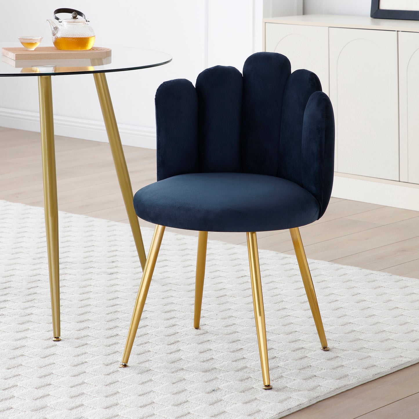 Deep blue velvet accent chair with scallop back and gold legs perfect for dining