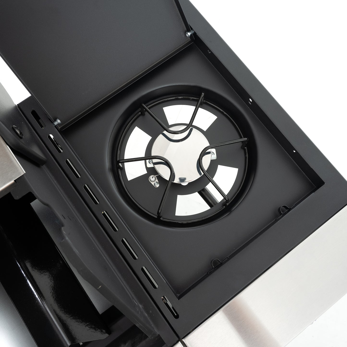Black gas hob burner grate with stainless steel central cap and reflective surface